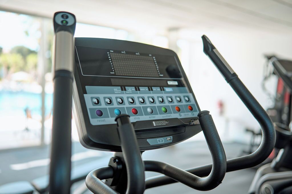 A stationary exercise bike with a digital display and control panel.