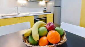 A kitchen with yellow cabinets, a sink, and a stove.