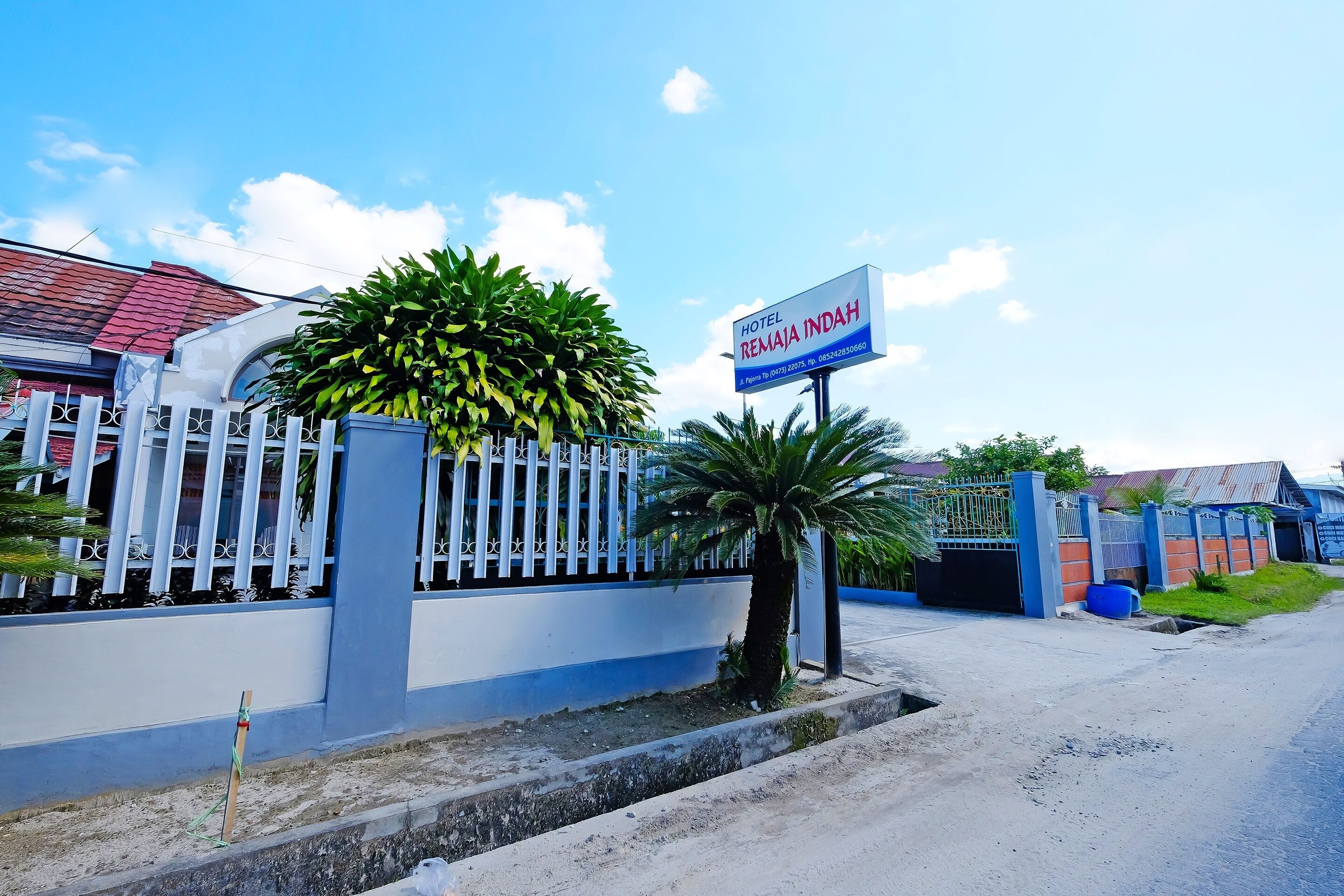 A gated property with a sign for Hotel Remaja Indah.