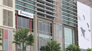 A hotel with a modern facade, multiple balconies, and a prominent signage for 'Saks Hotel'.