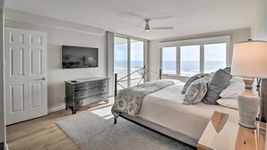 A bedroom with a bed, a dresser, a TV, and a view of the ocean. - Cambridge 404 - 3 Bedrooms - 2 Are Oceanfront - Amazing! (Pawleys Island)