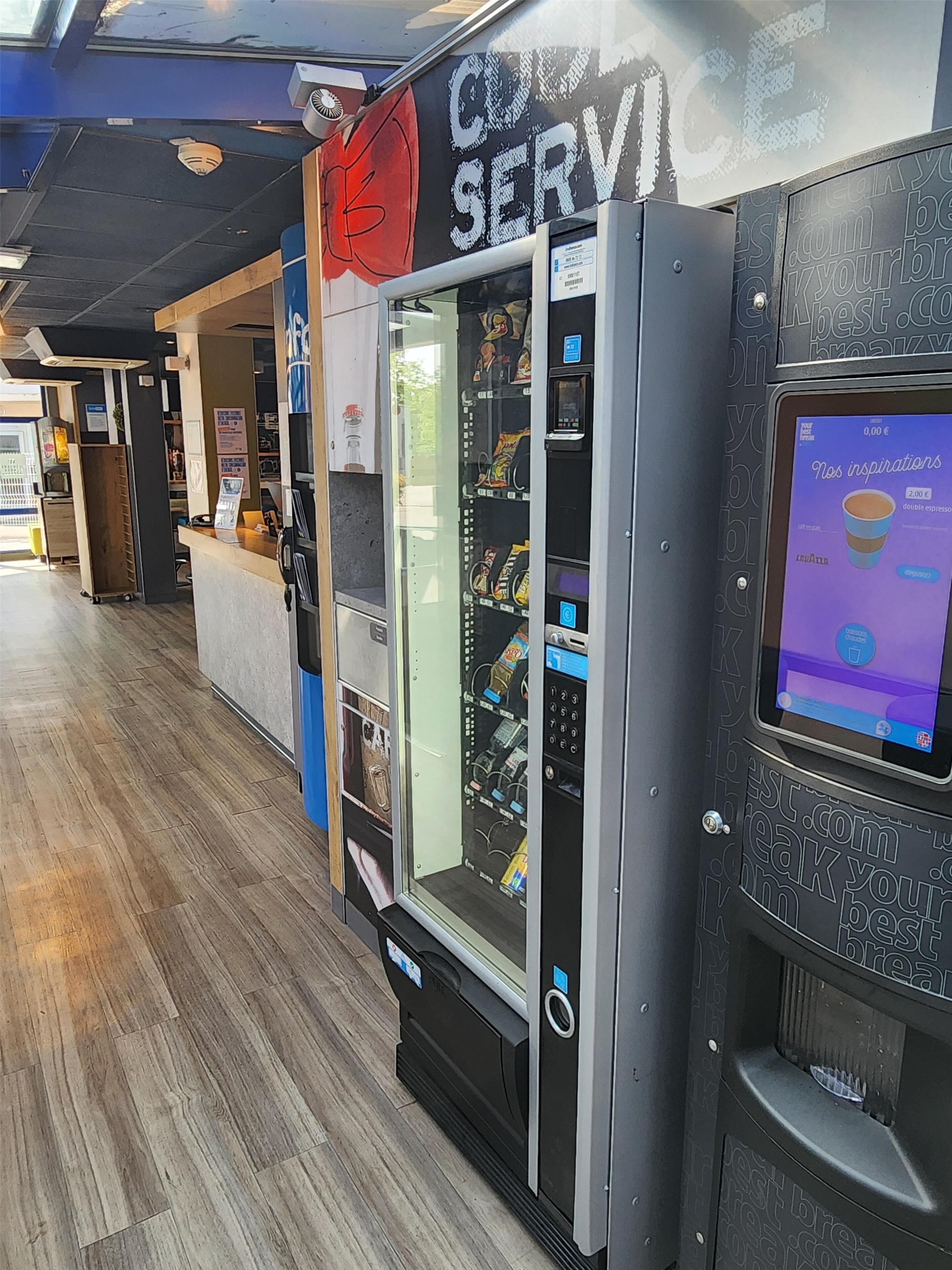 A vending machine with a digital screen displaying beverage options.