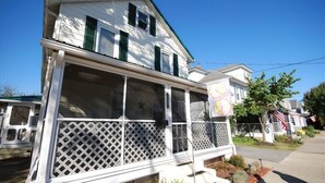 A two-story house with a porch and a star on the front door. - Just 1.5 Blocks to the Beach and Boardwalk! (Rehoboth Beach)