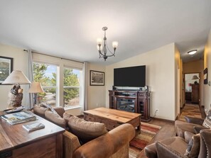 A living room with a sofa set, a coffee table, a TV, and a fireplace. - 3BR Mountain View - Covered Patio - Pet Friendly (Leadville)