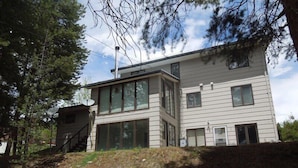 A modern two-story house with large windows, a satellite dish, and a small attached garage. - The Shamrock — 5BR Leadville Home, Game Room + 2-Car Garage, Sleeps 10 (Leadville)