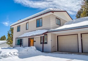 A two-story house with a garage, surrounded by snow. - The Shamrock — 5BR Leadville Home, Game Room + 2-Car Garage, Sleeps 10 (Leadville)