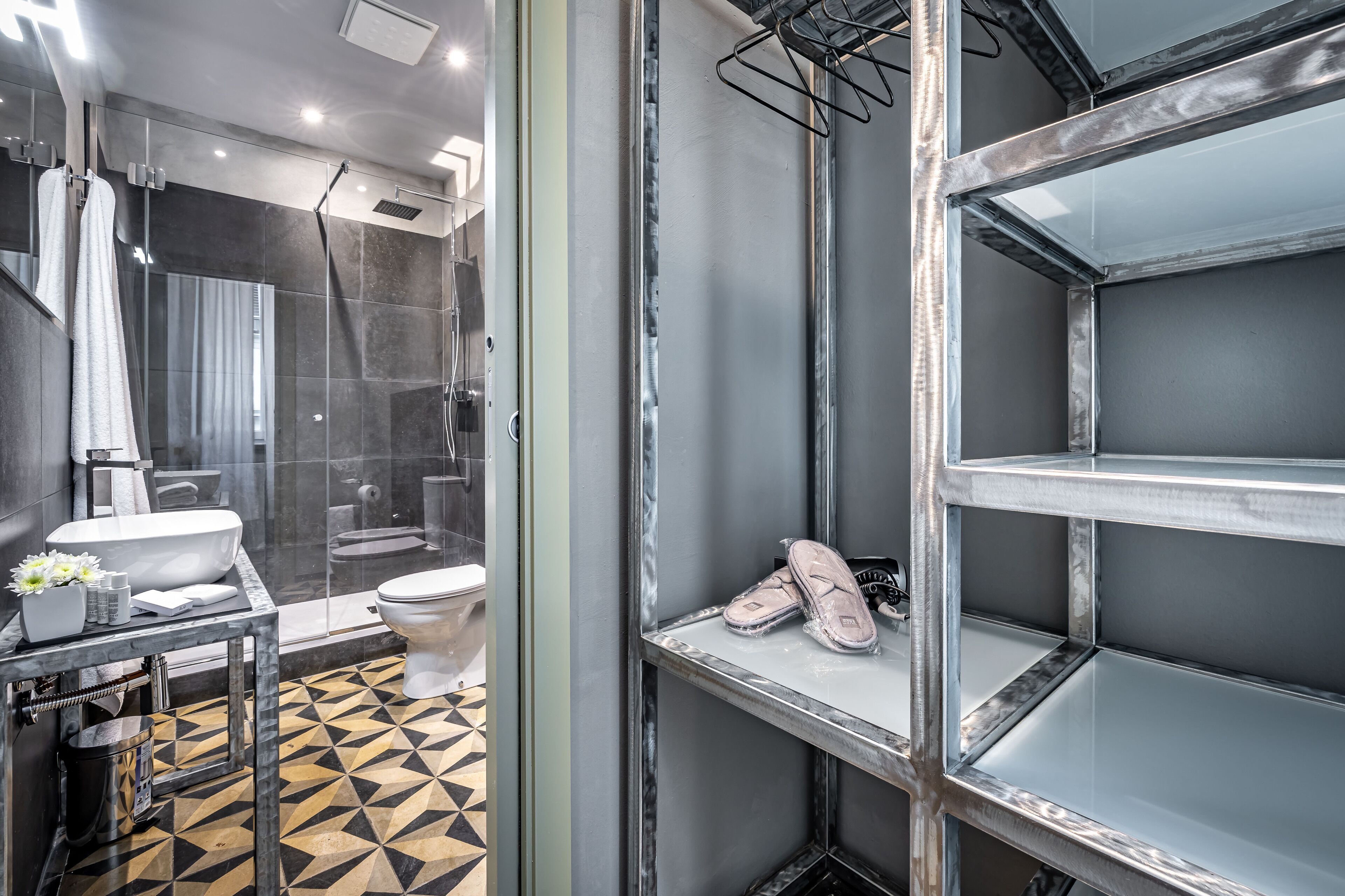A modern bathroom with a glass shower enclosure, a toilet, and a sink.