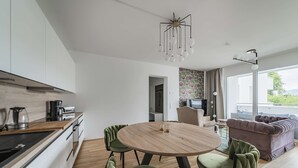 Una cocina moderna con comedor, un sofá y vistas al exterior.