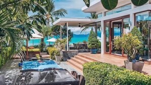 A modern outdoor lounge area with a pool, seating, and potted plants. - Huzhiyun Hotel (Chengjiang)