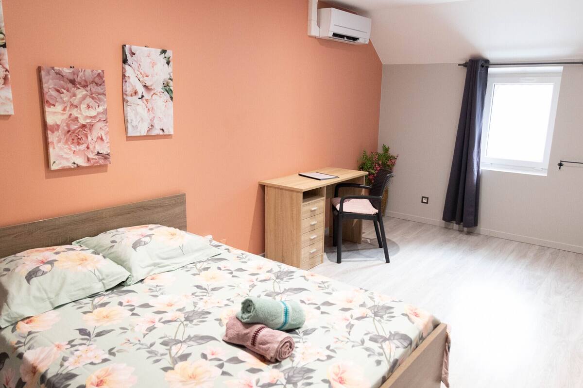 Ein Schlafzimmer mit einem Bett, einem Schreibtisch und einem Stuhl.