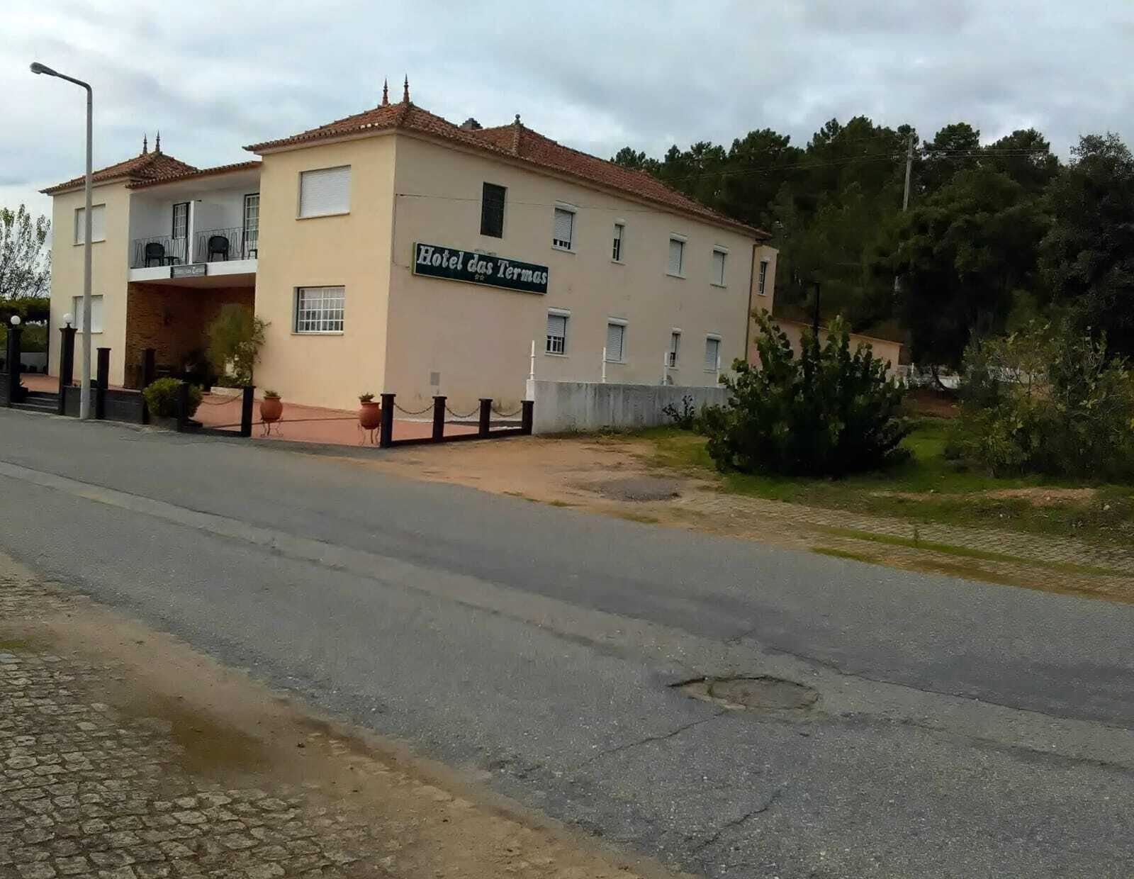A two-story building with a sign reading "Hotel das Termas."