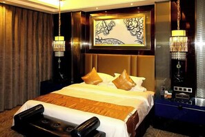 A hotel room with a large bed, a mirror, and two wall-mounted lamps. - Shandong Building (Shigatse)