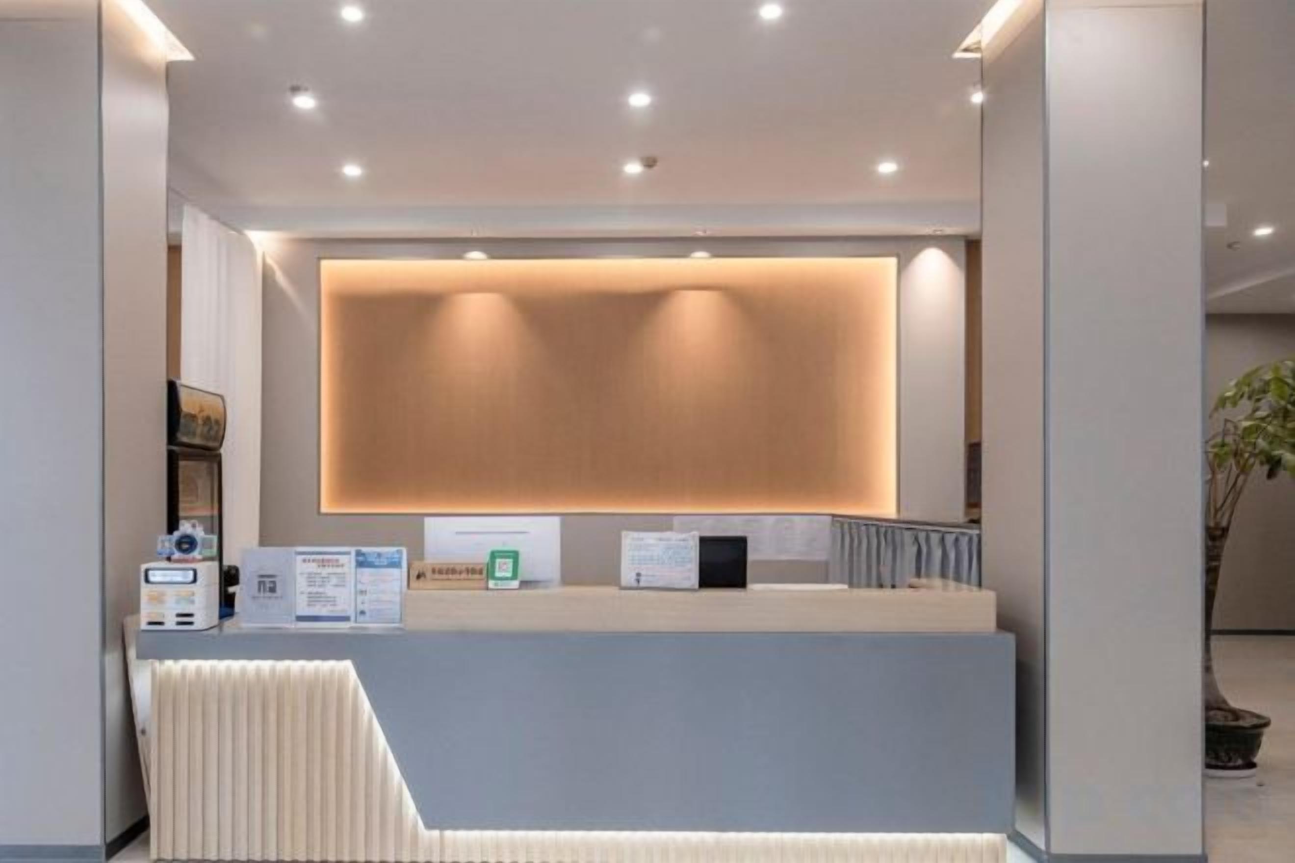 A reception desk with a modern design, a counter, and a seating area.