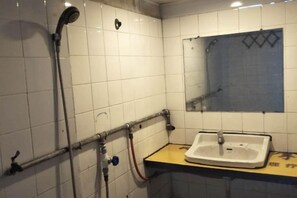 A bathroom with a sink, mirror, and shower. - Dashijie Hostel (Shengzhou)