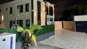 A modern building with a flat roof, large windows, and a well-lit entrance. - Northwold Hotel-Sowutuom Accra (Accra)