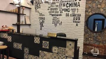 A reception desk with a patterned wall and a stone accent wall.