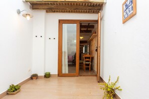 A wooden-framed sliding door leading to an interior space with a dining table and chairs.