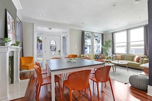 Relax in a stylish living area with a large dining table, comfortable sofa, and fireplace.