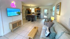 A modern apartment with a living room, kitchen, and dining area. - The Sand Dollar – Charming Bungalow in Gulfport, Minutes from Downtown St. Pete (Gulfport)
