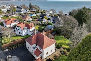 Stunning residential neighborhood with beautifully maintained gardens and serene views of a large body of water.