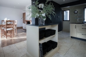 Enjoy meals at the dining table, surrounded by a vase of fresh flowers and natural light.