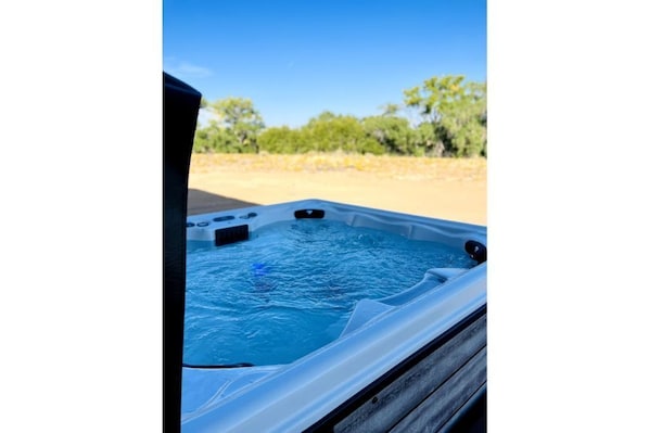 Relax in a serene outdoor hot tub, surrounded by nature.