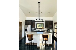 Enjoy dining or socializing at the kitchen island with bar stools.