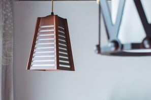 Un luminaire suspendu, de type suspension, doté d’un design géométrique et fixé au plafond.