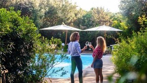 Two people standing by a pool with umbrellas. - Resort Riva degli Etruschi, San Vincenzo (San Vincenzo)