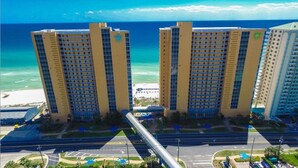 A high-rise hotel with multiple floors, a beach view, and a parking area in the foreground. - Fall @ Splash!  October/ November Open! (Panama City Beach)