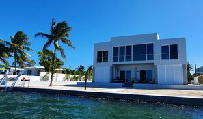 Enjoy a relaxing stay in this beachfront property with a poolside bar and covered outdoor seating area.