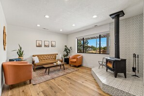 A living room with a sofa, armchair, and a fireplace. - The Getaway in Williams  (Williams)
