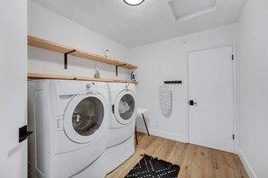 Laundry room with washer, dryer, ironing board and a high chair. - The Getaway in Williams  (Williams)