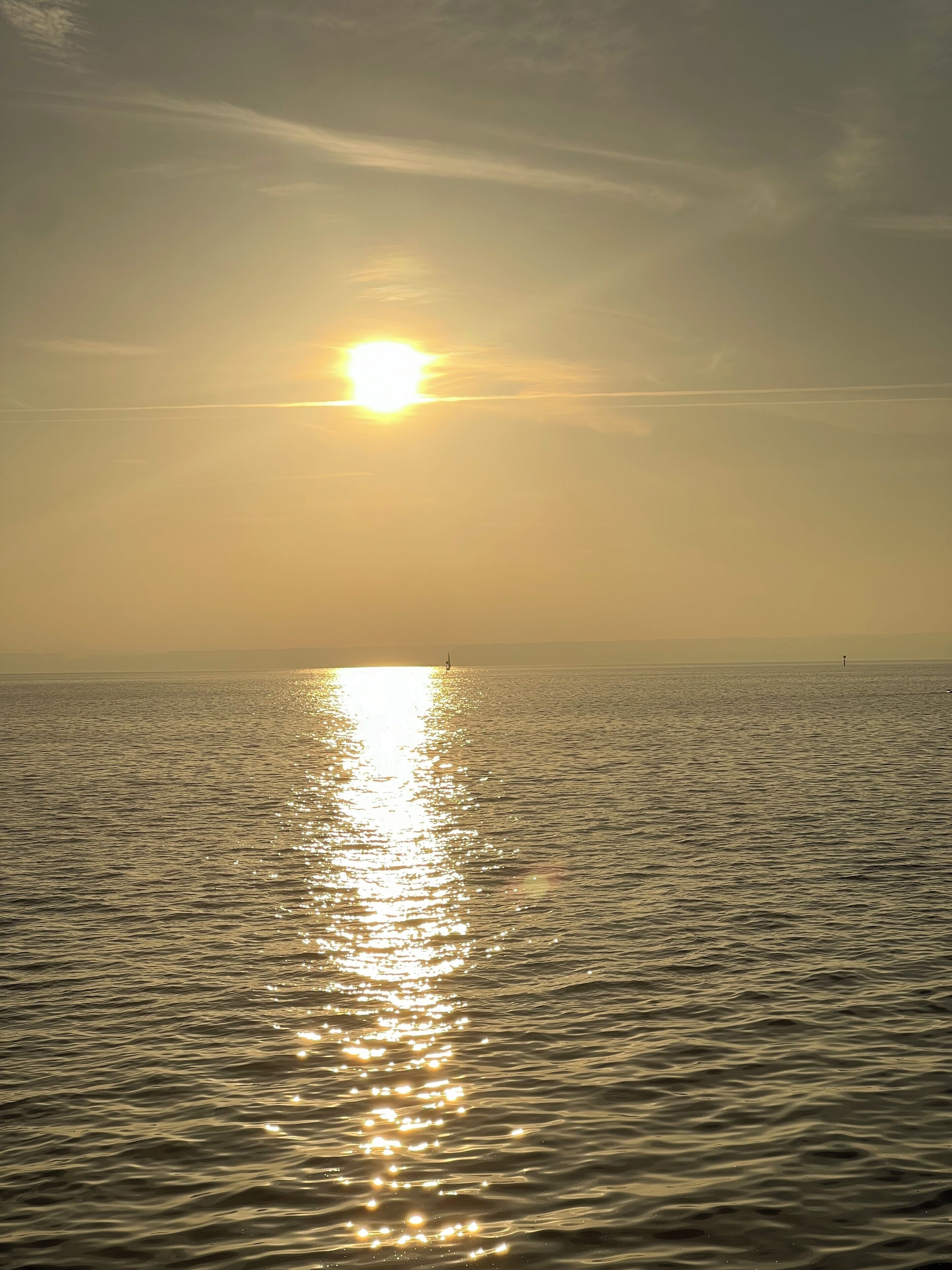 A calm sea reflecting the sun.