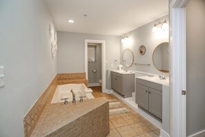 A modern bathroom with a freestanding bathtub, two sinks, and a large mirror. - Club at Mexico Beach 1G Red Fish Blue Fish (Port St. Joe)