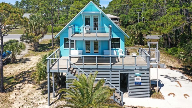 A two-story beachfront house with a balcony, a small deck, and a sign indicating 'Private Properties'. - Seas of Jade (Port St. Joe)