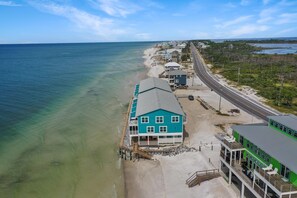 A coastal property with a large house and a smaller building, both with balconies and direct beach access. - The Hidden Pearl (Port St. Joe)