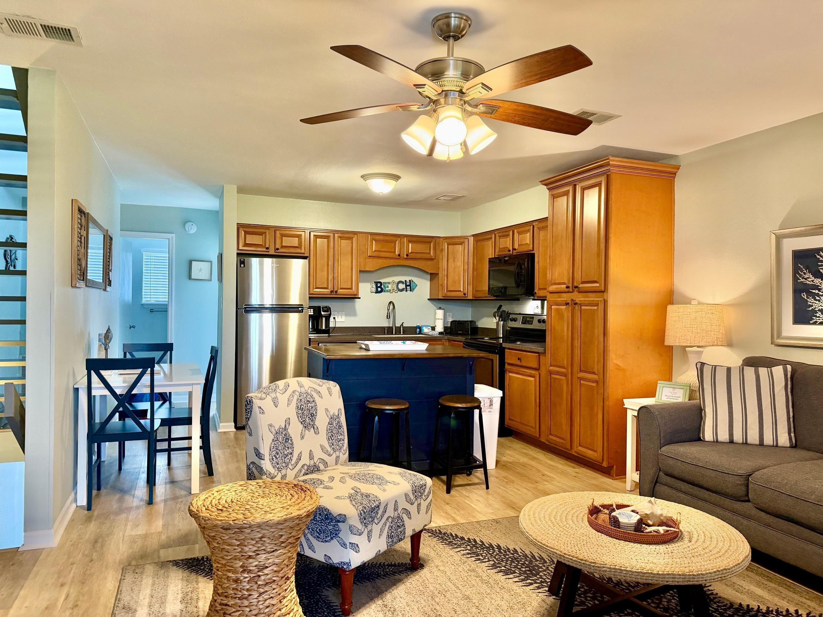 A modern kitchen with wooden cabinets, a built-in microwave, and a stainless steel refrigerator.