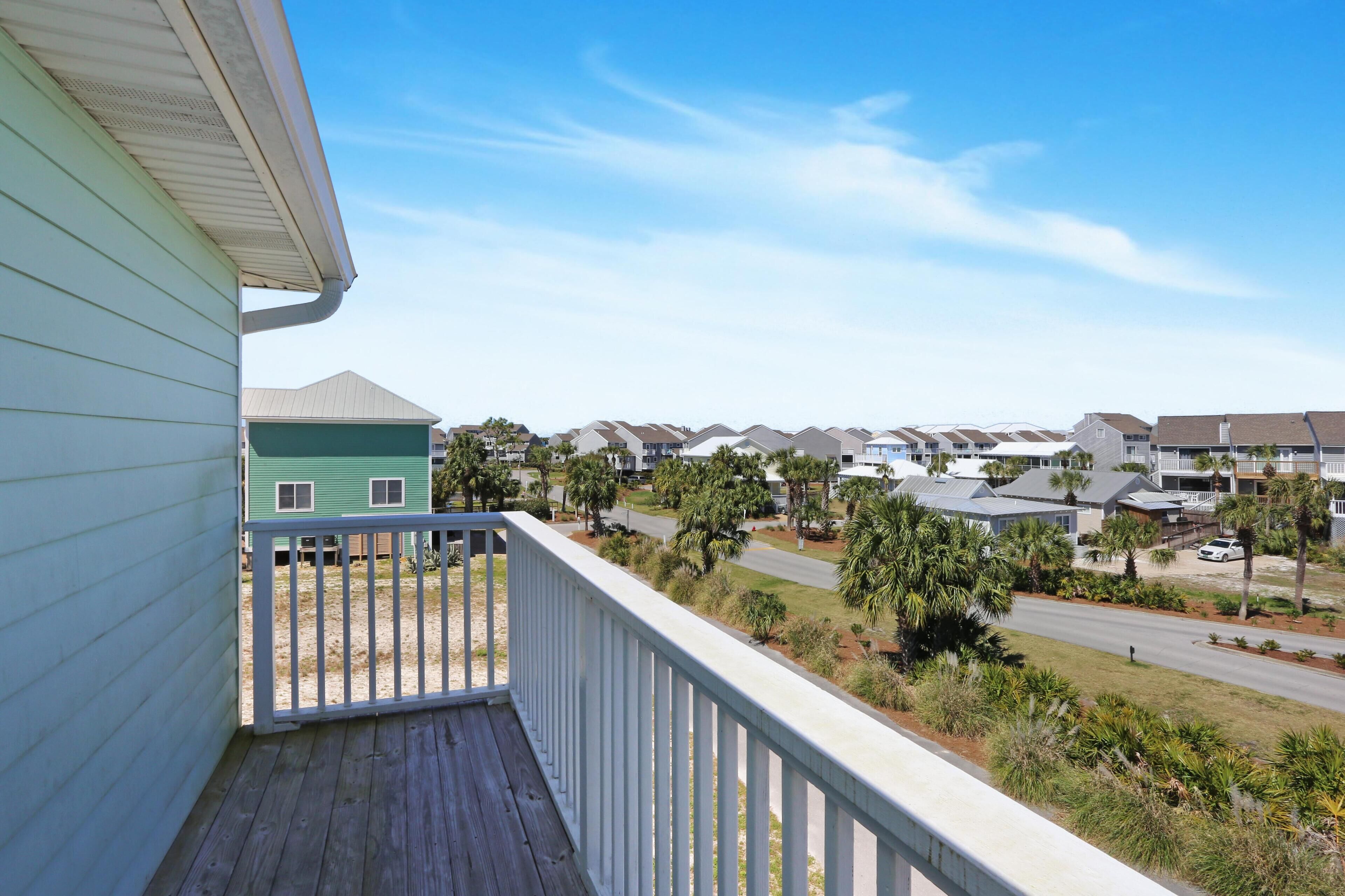 A residential area with a view of a row of houses and a clear sky.
