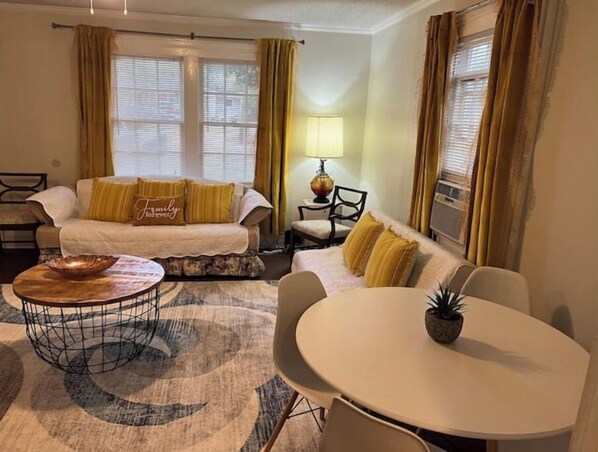 Relax in a tastefully decorated room with a cozy seating area, dining space, and modern amenities.