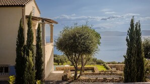 A Mediterranean-style villa with a pool, cypress trees, and a view of the sea. - Villa Comi (Kefalonia)