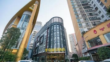 A multi-story building with a curved facade and a large entrance.