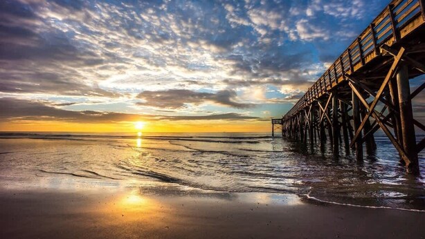A pier extending into a calm sea at sunset with a clear sky. - Relax & Enjoy Life! Updated Wild Dunes Condo (Isle of Palms)