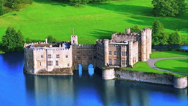 A castle with a moat, surrounded by green fields and a body of water. - 70s Inspired, 3-Bed Home in Rye with river views (Rye)