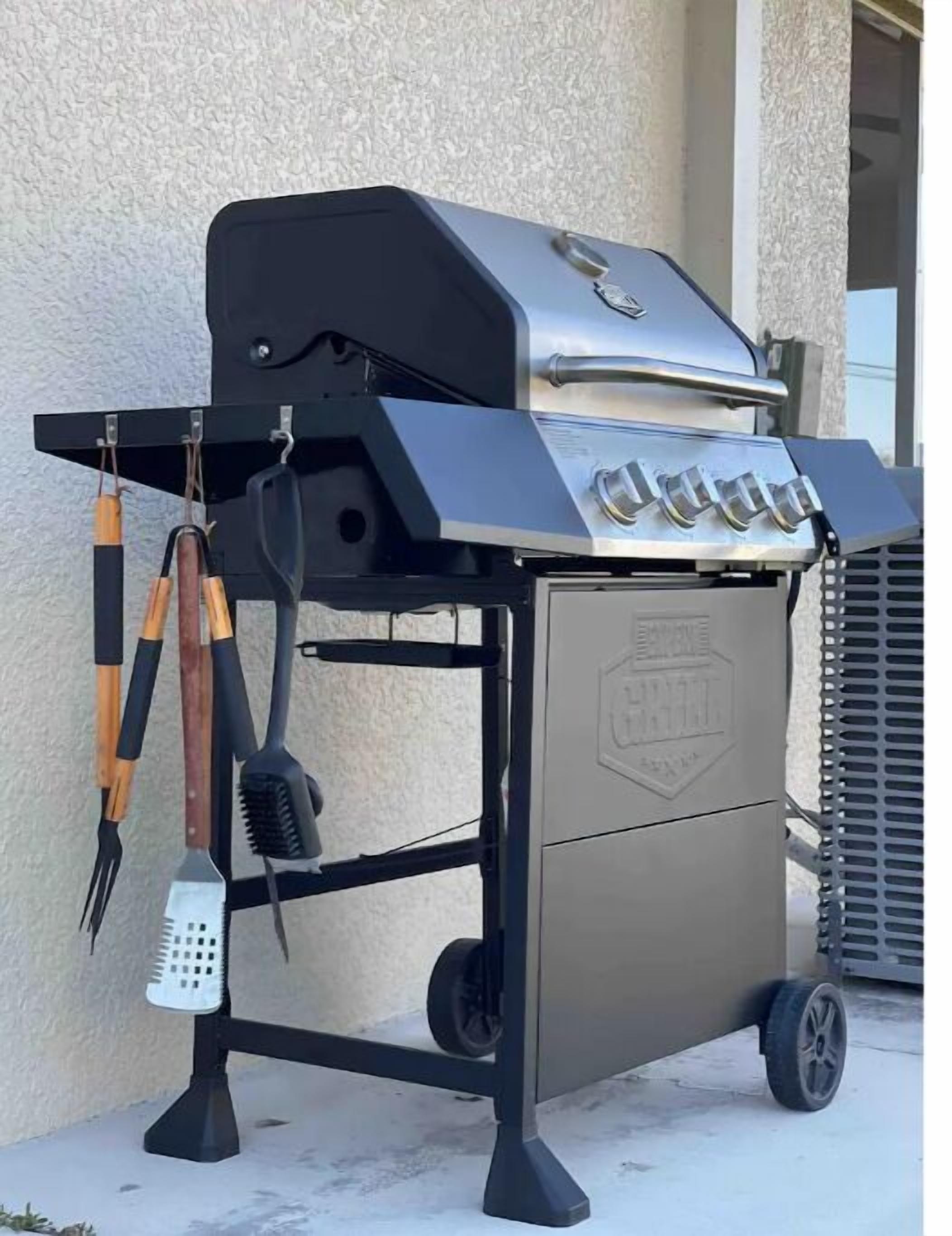 A portable grill with a side shelf, a handle, and a logo on the side.
