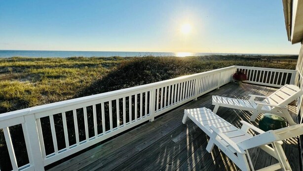 A wooden deck with white railings and two white lounge chairs facing a beach. - "Beach Box" BHI and Shoals Club, Pet Friendly, Ocean Views, Steps To Beach (Bald Head Island)