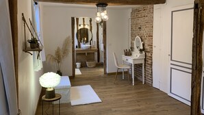 Un baño con tocador de madera, un espejo y un lavamanos.
