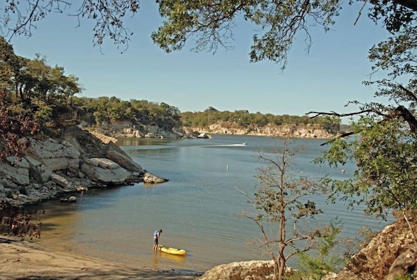 Enjoy serene views of the calm river from the riverbank, where you can kayak or explore the surrounding lush landscape.