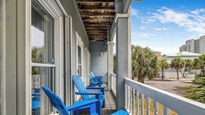 A balcony with blue Adirondack chairs and a white railing. - When the Sun Goes Down 🌅 Navarre Retreat w/Golf Cart, Boat Slip + Pet Friendly (Navarre)