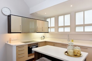Enjoy cooking in this well-equipped kitchen with a stove, oven, and double sink.